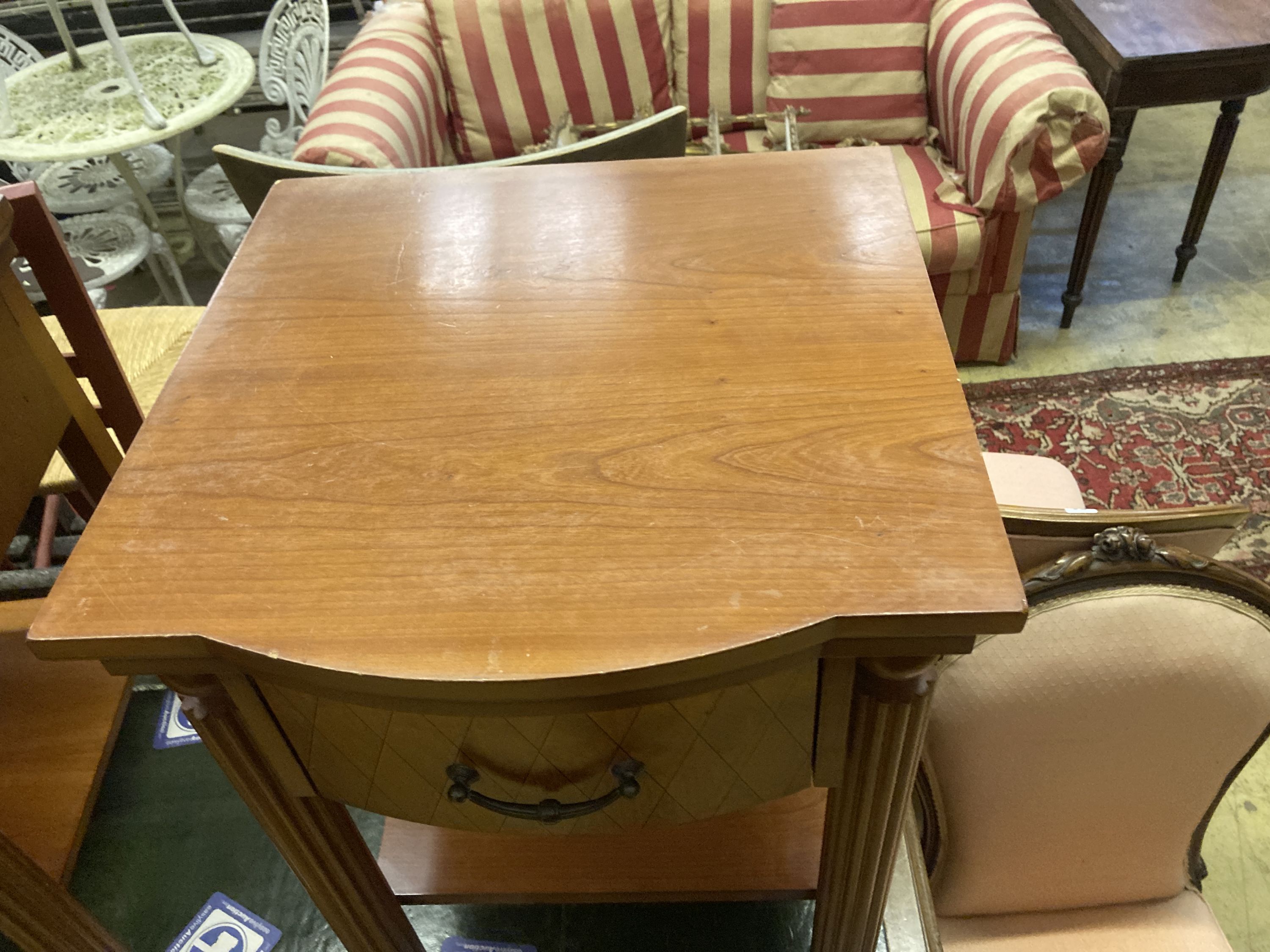 A pair of walnut bowfront two tier bedside tables, width 50cm, depth 50cm, height 61cm